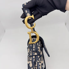Load image into Gallery viewer, Dior blue oblique monogram jacquard medium saddle bag, with gold hardware and guitar strap